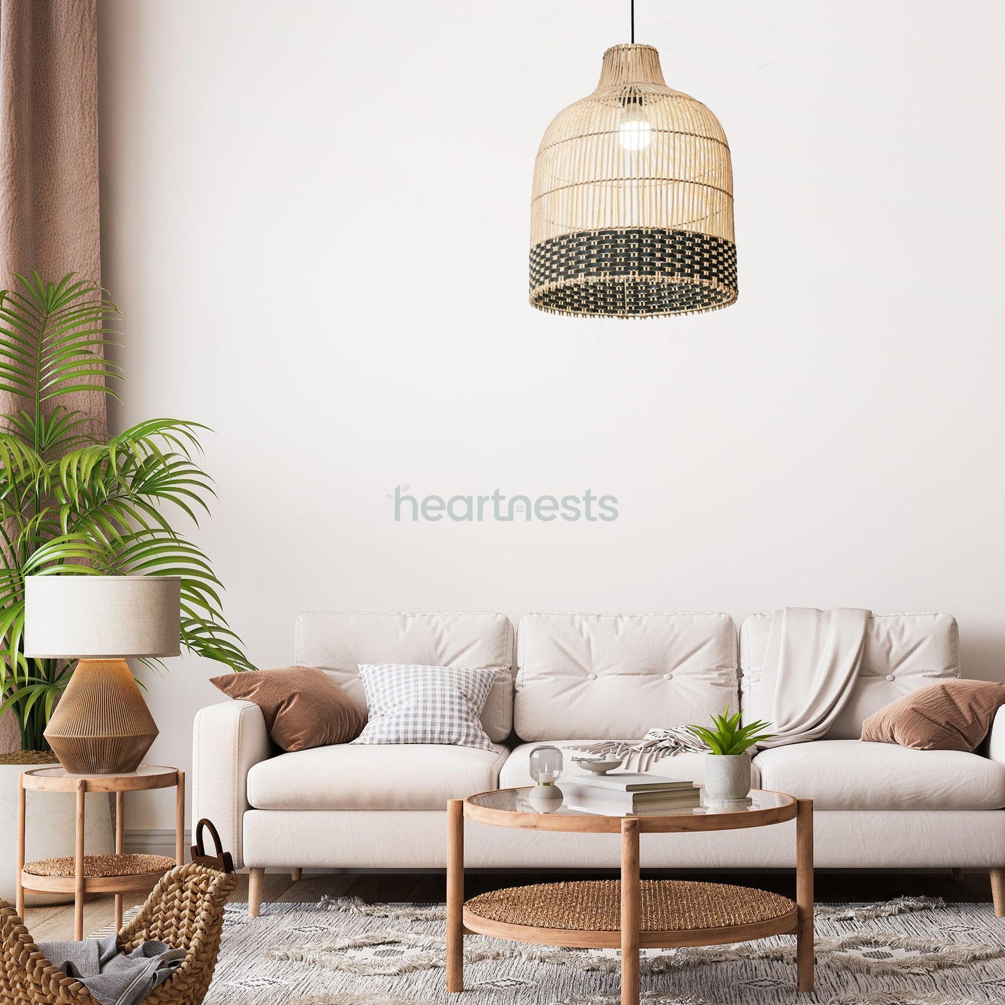 Heartnests's Ayla rattan hanging light is hung above a small wooden living room table and a neutral tone cloud chase sofa standing next to a pot plant, a wooden stool with a table lamp