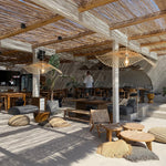 2 of Heartnests' Hakea Handmade Wicker Pendant Lights are hung side by side in a retreat style restaurant