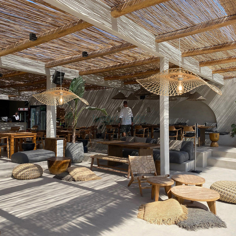 2 of Heartnests' Hakea Handmade Wicker Pendant Lights are hung side by side in a retreat style restaurant